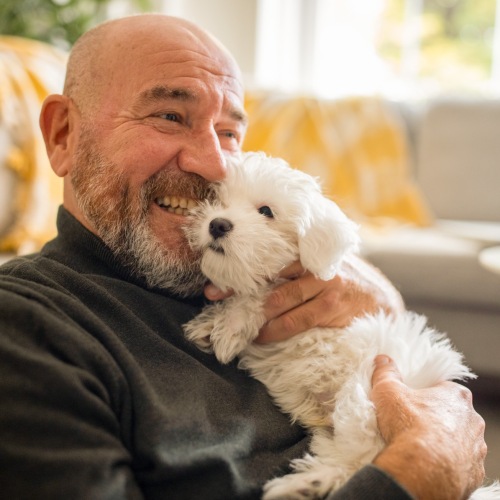a man hugging his puppy