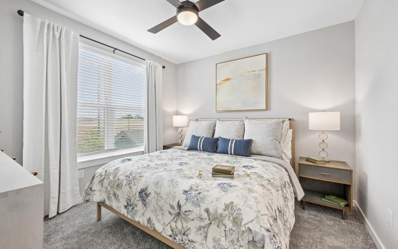 a bedroom with a bed and a fan