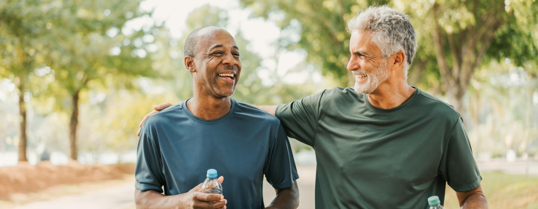 a couple of men holding water bottles and walking