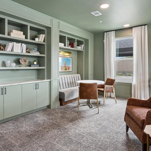 a room with a tv and chairs